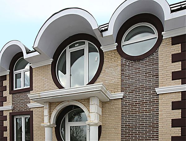 Овальные окна особняка оформлены арками из полиуретана.